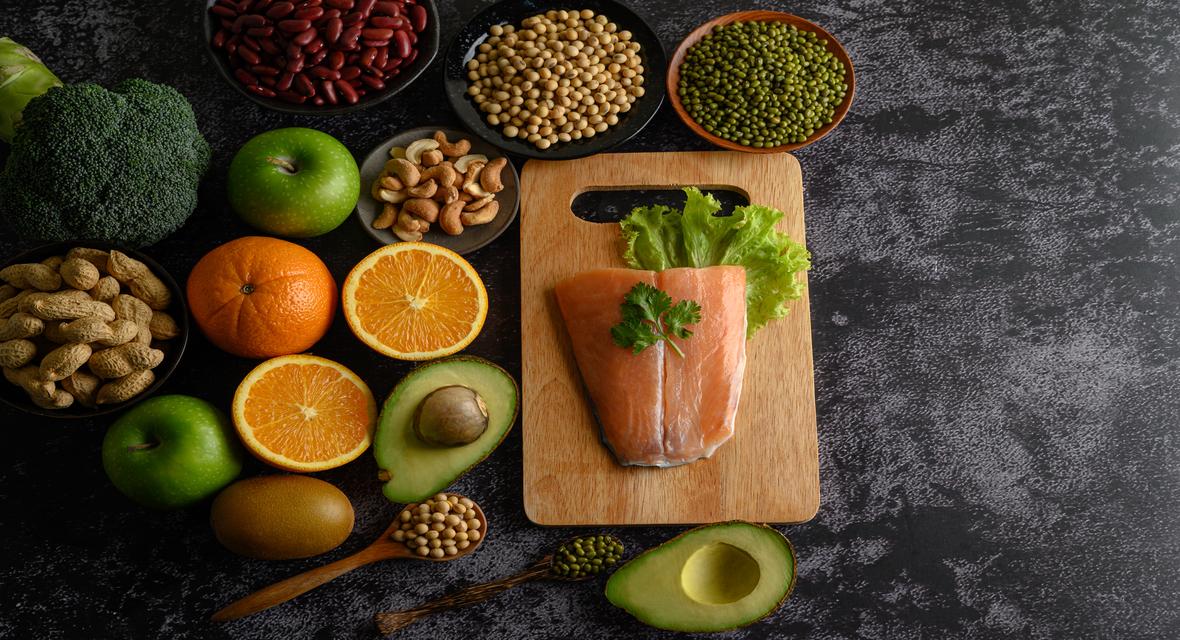 Immunity-boosting foods including salmon, broccoli, oranges, avocado, beans, and nuts